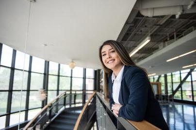 A female student smiling in the skybridge